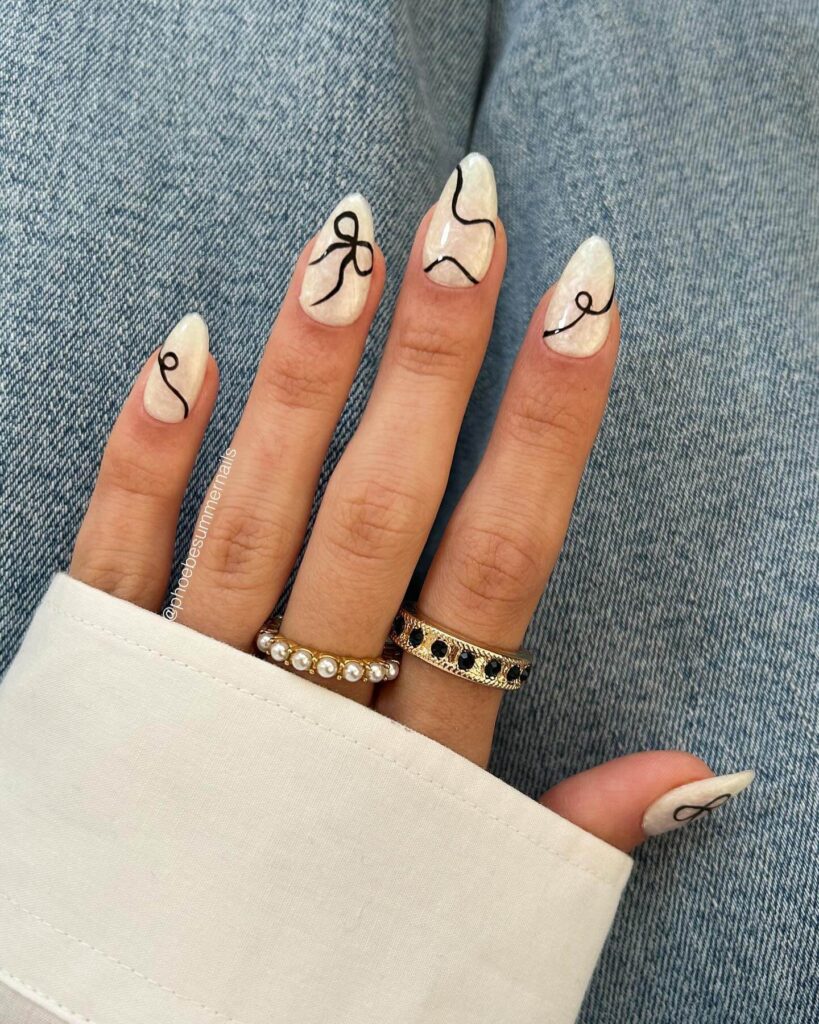 Chic almond nails with a subtle ombre design, combining pastel tones for a classic and modern look