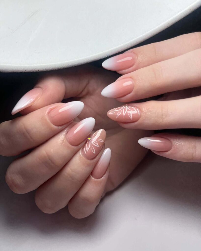 Chic almond nails with a subtle ombre design, combining pastel tones for a classic and modern look