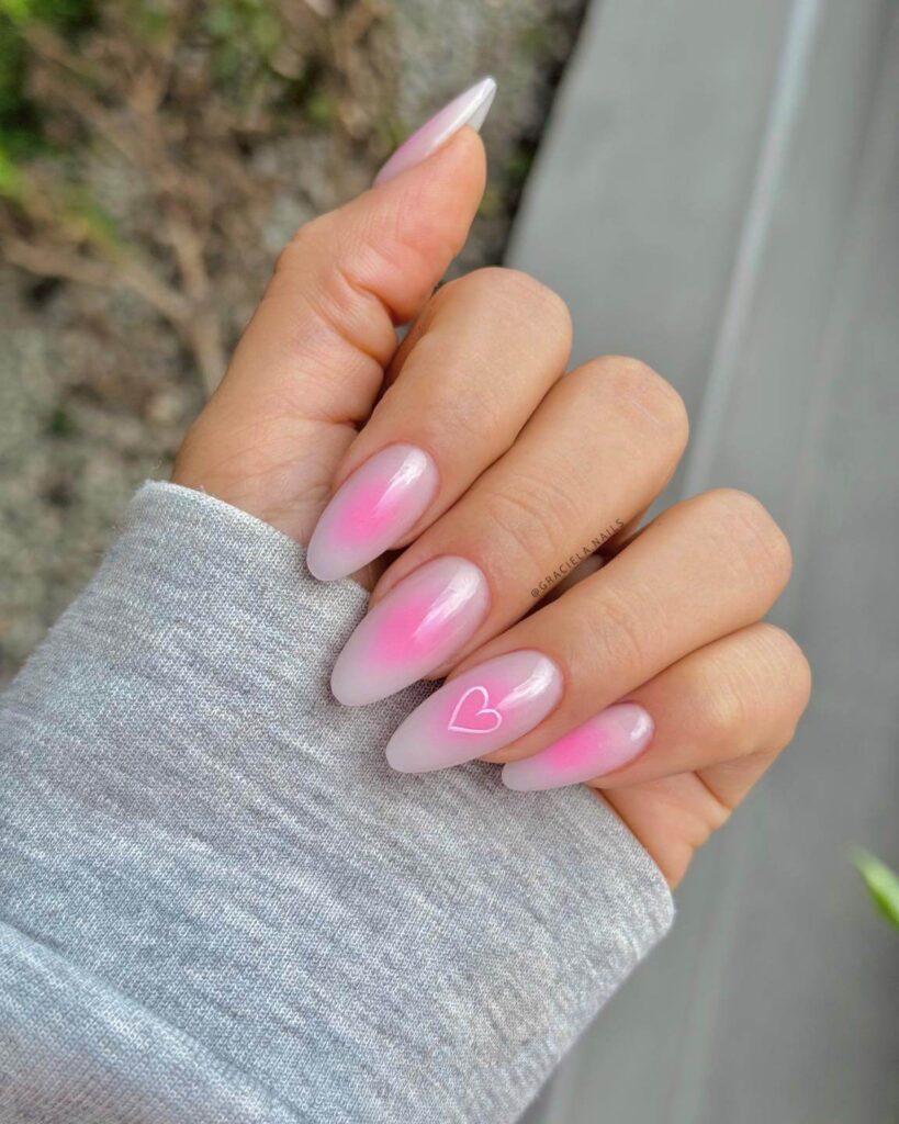 Chic almond nails with a subtle ombre design, combining pastel tones for a classic and modern look