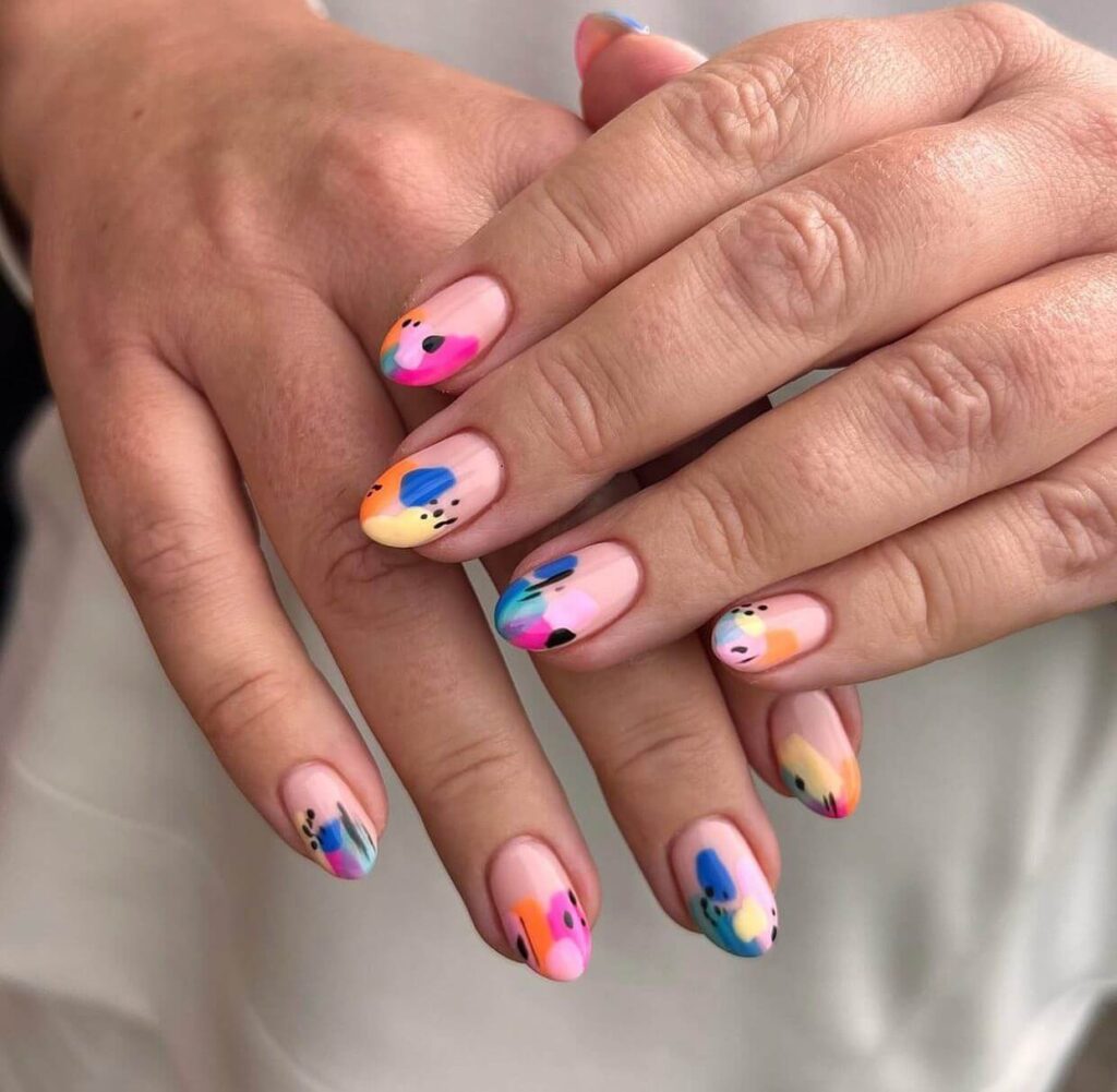 Abstract nail art with vibrant geometric designs and bold color patterns, perfect for creative manicures