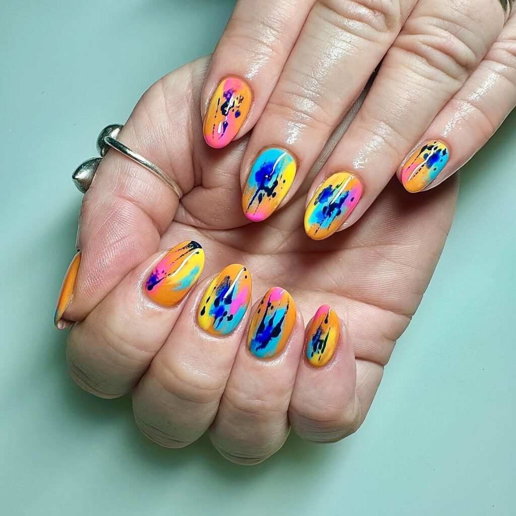 Abstract nail art with vibrant geometric designs and bold color patterns, perfect for creative manicures