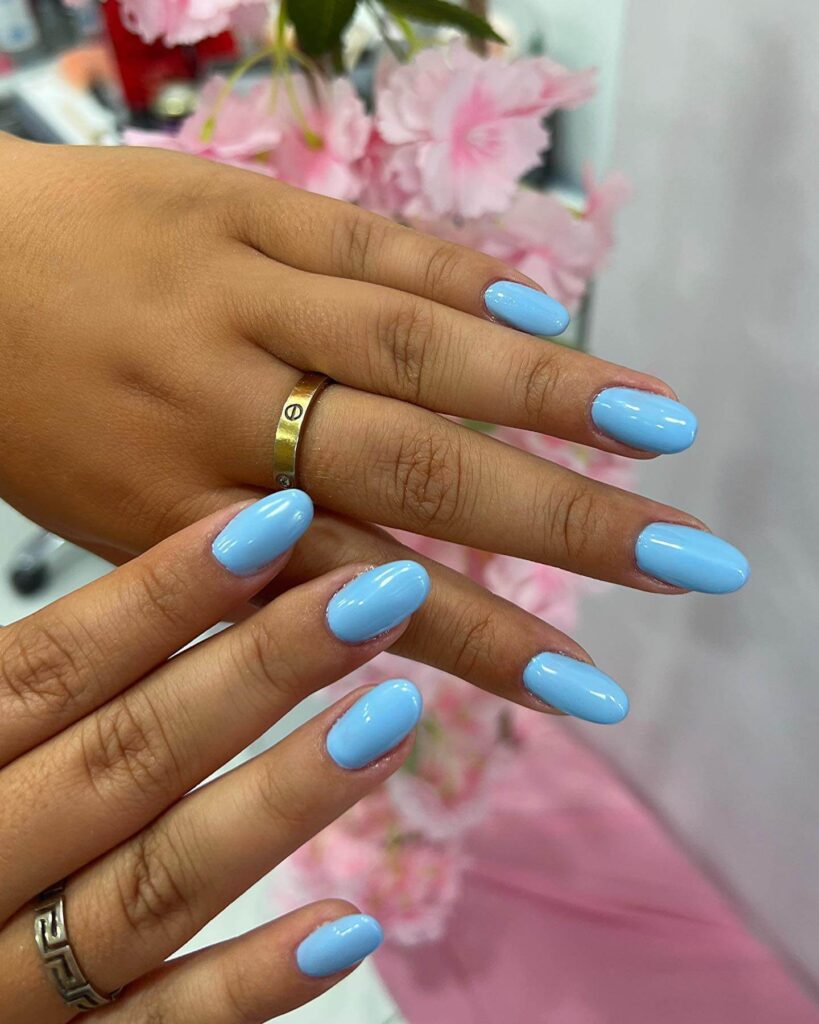 Stylish sky blue nails with a glossy finish, perfect for fresh and modern spring or holiday nail designs