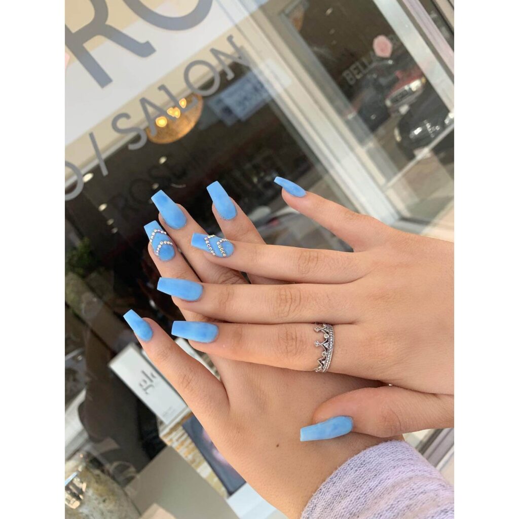 Stylish sky blue nails with a glossy finish, perfect for fresh and modern spring or holiday nail designs