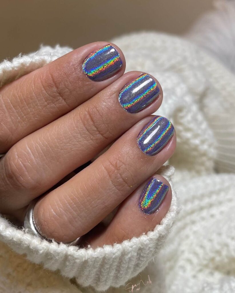 Holographic nails with chrome effects, featuring high-shine pigment and trendy mirror-like finishes for a futuristic look