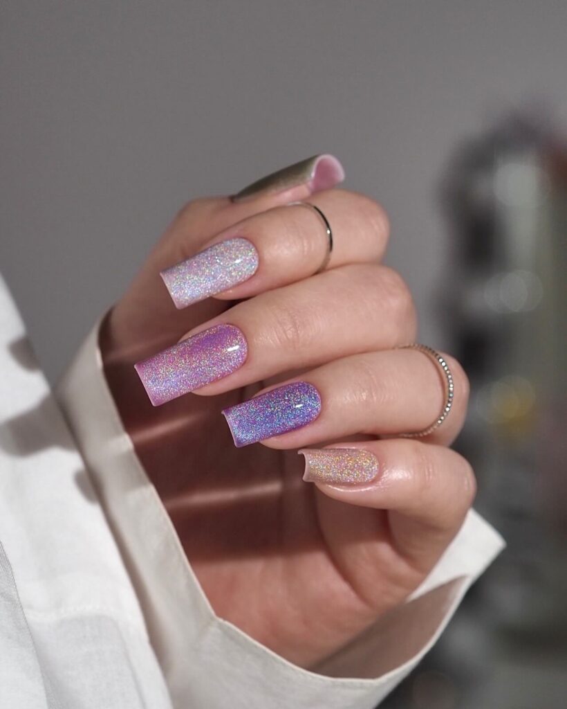 Holographic nails with chrome effects, featuring high-shine pigment and trendy mirror-like finishes for a futuristic look