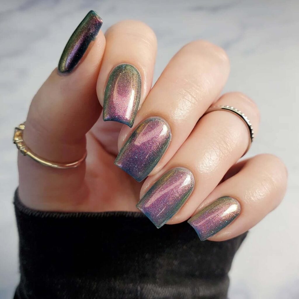 Holographic nails with chrome effects, featuring high-shine pigment and trendy mirror-like finishes for a futuristic look