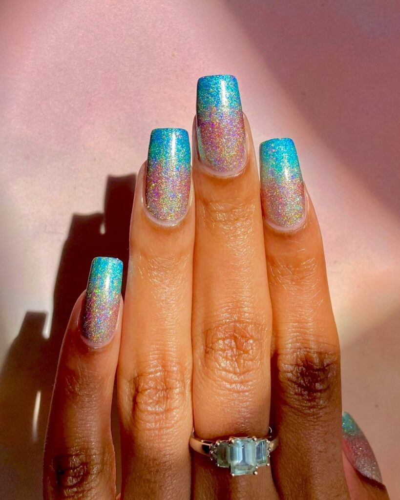 Holographic nails with chrome effects, featuring high-shine pigment and trendy mirror-like finishes for a futuristic look